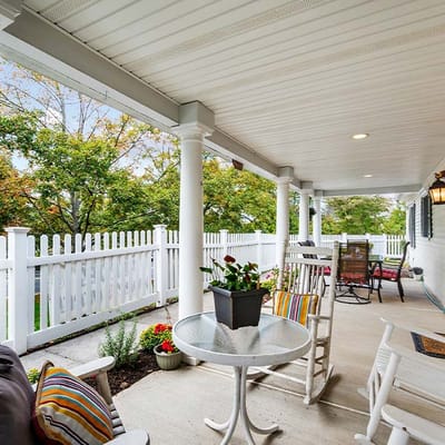 Outdoor seating area with flowers and rocking chairs