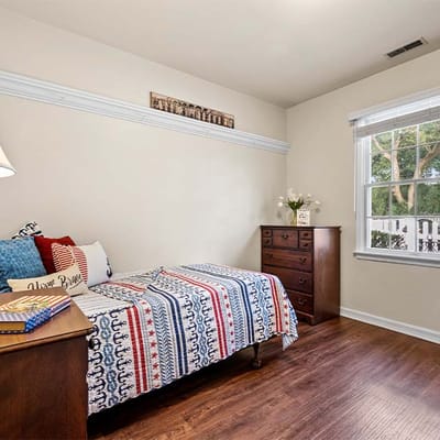 Cozy private resident room with a bed and dresser