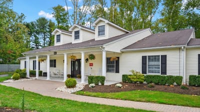 Exterior view of a senior living facility with landscaped entrance