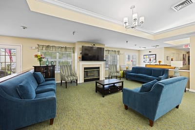 Bright common area with comfortable seating and a fireplace