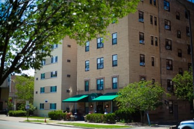 Exterior view of Greenwood Care facility with outdoor seating