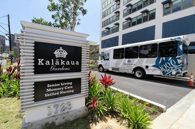 Facility sign with logo and shuttle bus in view