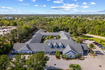 Aerial view of a senior living facility surrounded by greenery