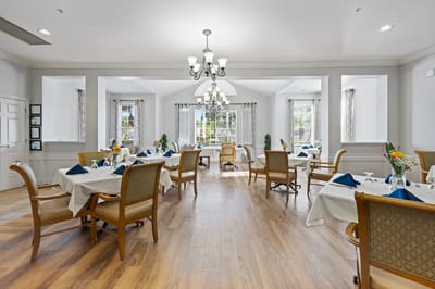Brightly lit dining room with elegant table settings