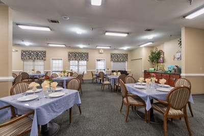Dining room setup with tables and chairs