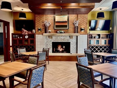 Cozy dining room with a fireplace and wooden tables
