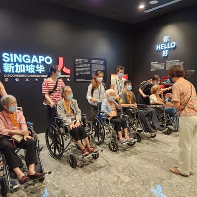Residents in wheelchairs engaged in a cultural event