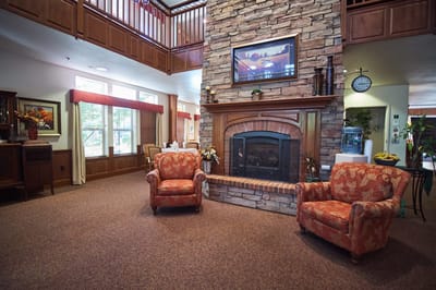Cozy common area with a stone fireplace and seating