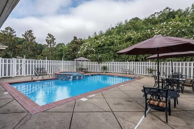 Swimming pool area with lounge chairs and umbrellas