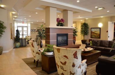 Interior of a cozy common area with seating and plants