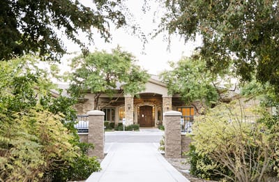 Entrance of Emerald Groves Assisted Living surrounded by trees