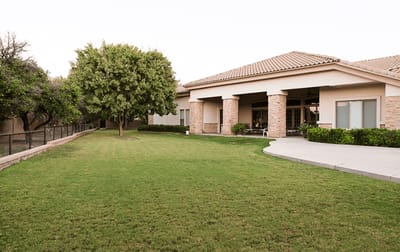 Exterior view of Emerald Groves Assisted Living building and lawn