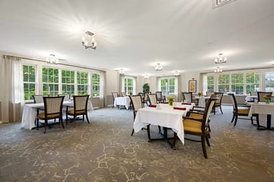 Bright dining room with tables set for meals