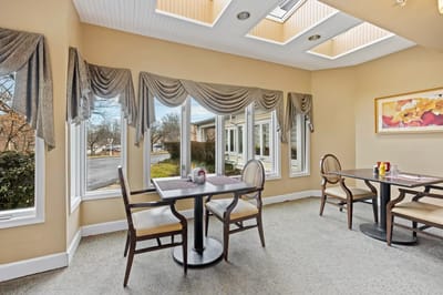Bright dining area with large windows and tables