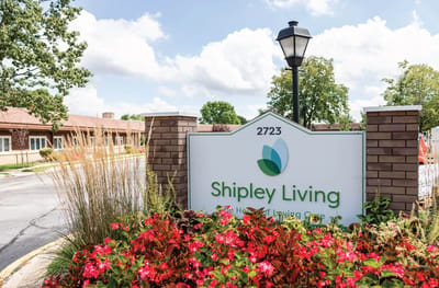 Sign for Shipley Living with flowers in the foreground