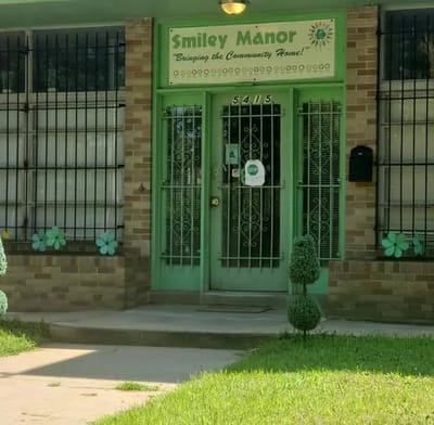 Exterior view of Smiley Manor with entrance and landscaping