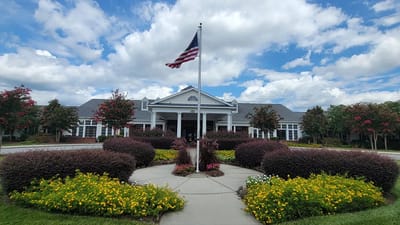 Front exterior of Spring Arbor of Greensboro with landscaped area