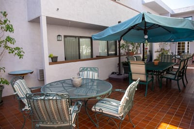Outdoor patio area with seating and shade