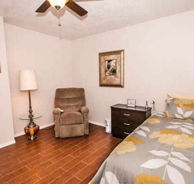Cozy resident room with a bed and chair