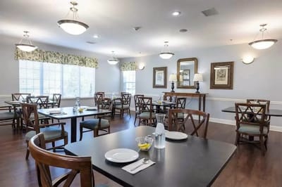 Bright dining room with tables set and food visible