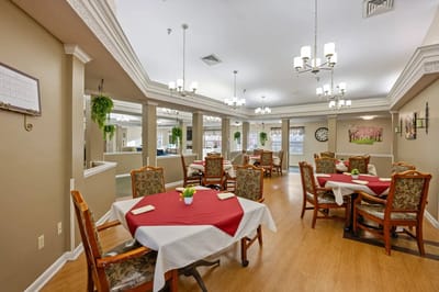 Dining area with tables and chairs set for meals