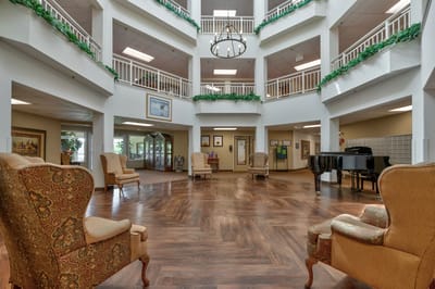 Bright, inviting common area with seating and piano