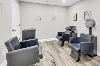 Bright, clean hair salon area with chairs and equipment