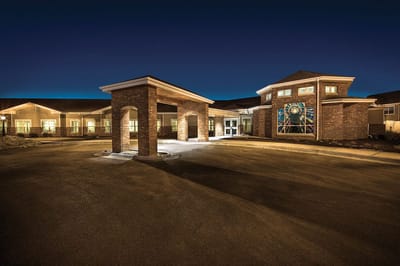 Exterior view of The Lighthouse senior living facility at night