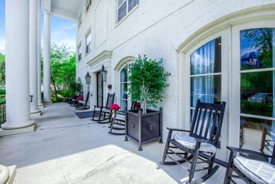 Exterior view of the facility with seating area and plants