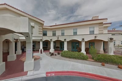 Exterior view of assisted living facility with covered entrance