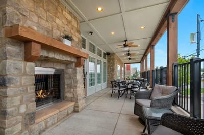 Outdoor seating area with a fireplace and tables