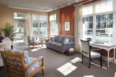 Bright common area with seating and large windows
