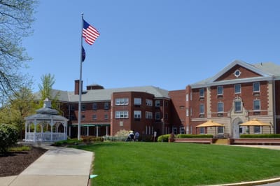 Exterior view of Asbury Heights with residents outdoors