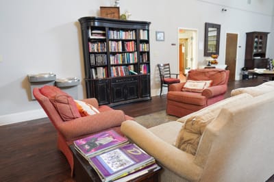 Cozy common area with seating and bookshelves