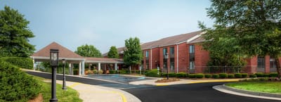 Exterior view of a senior living facility with landscaped entrance