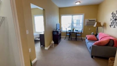 Bright, cozy resident room with a small dining area
