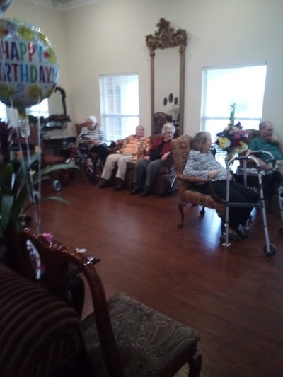 Residents enjoying a birthday celebration in the common area