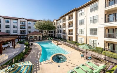 Outdoor pool area with seating and lounge chairs