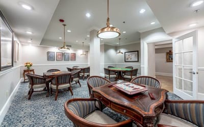 Common area with tables and chairs for residents