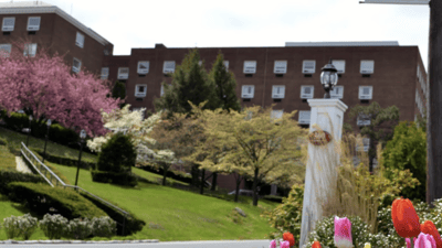Exterior view of the facility with gardens and flowers.