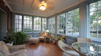 Bright sunroom with comfortable seating and plants