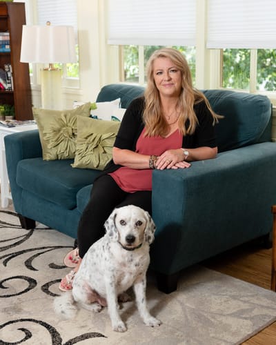Resident sitting on a couch with a dog
