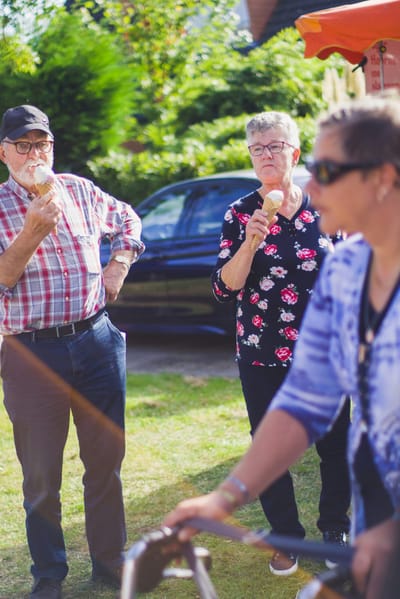 Seniors enjoying ice cream outdoors.