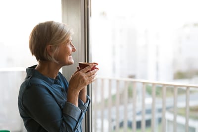 Senior woman enjoying a cup of coffee indoors