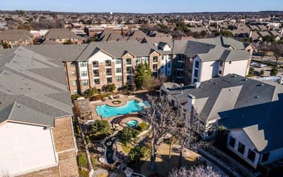 Aerial view of a senior living facility with a pool