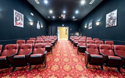 Interior view of a cinema room with red seating