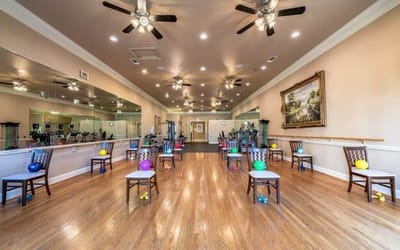 Interior fitness room with exercise equipment and fitness balls