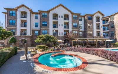 Exterior view of a senior living facility with a pool