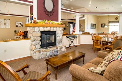 Common area with seating and fireplace in a senior living facility