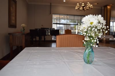 Table setting with a floral centerpiece in the common area